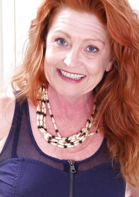 Curious british redheaded aged Veronica Smith reveals big boobs and spreads her legs 